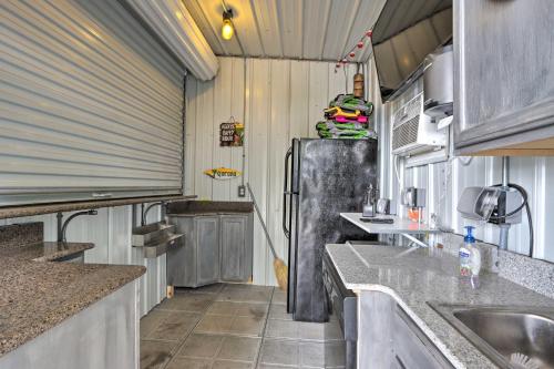 a kitchen with a refrigerator in a trailer at Boat Dock and Fire Pit Luxe Osage Beach Lake House! in Osage Beach