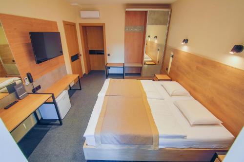 a room with several beds and a flat screen tv at Sport Hotel 1 in Cherkasy