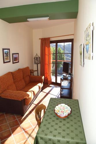 a living room with a couch and a table at VACACIONAL LA TEA THE BEST LOCATION and THE BEST VIEWS in Tejeda