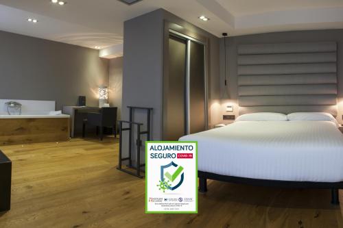a bedroom with a bed with a sign in front of it at Zenit Vigo in Vigo