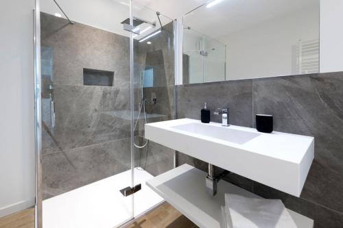 a bathroom with a white sink and a shower at Residence La Torre con private park in Trieste
