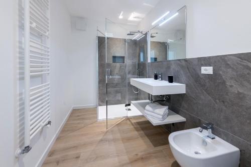a bathroom with a sink and a toilet and a shower at Residence La Torre con private park in Trieste