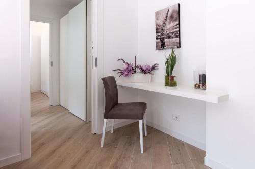 a white desk with a chair in a room at Residence La Torre con private park in Trieste