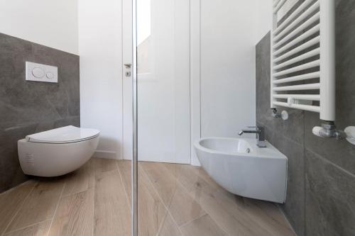 a bathroom with a shower and a toilet and a sink at Residence La Torre con private park in Trieste