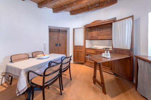 a kitchen and dining room with a table and chairs at Residence La Torre con private park in Trieste