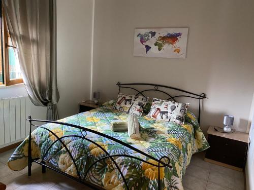 sypialnia z łóżkiem z kolorową kołdrą i poduszkami w obiekcie La Casa al Bacio w mieście Perugia