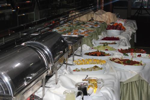 a buffet line with many different plates of food at Altinnal Hotel in Kocaeli