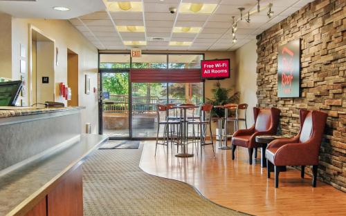 a bar in a hospital lobby with chairs and a counter at Red Roof Inn Cleveland Airport - Middleburg Heights in Middleburg Heights