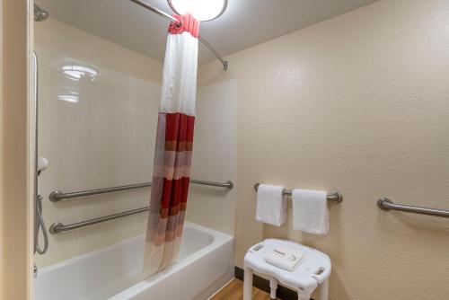 a bathroom with a shower and a tub and a toilet at Red Roof Inn Cleveland Airport - Middleburg Heights in Middleburg Heights