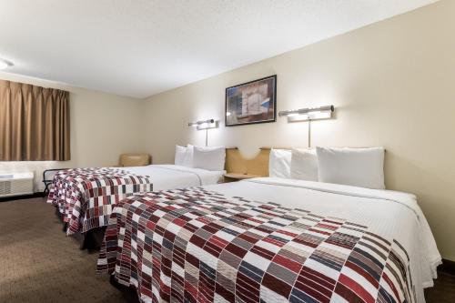 a hotel room with two beds and a window at Red Roof Inn Cleveland Airport - Middleburg Heights in Middleburg Heights