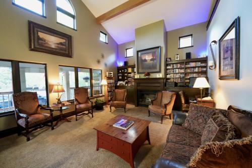 a living room with a couch and chairs and a fireplace at Frisco Inn on Galena in Frisco