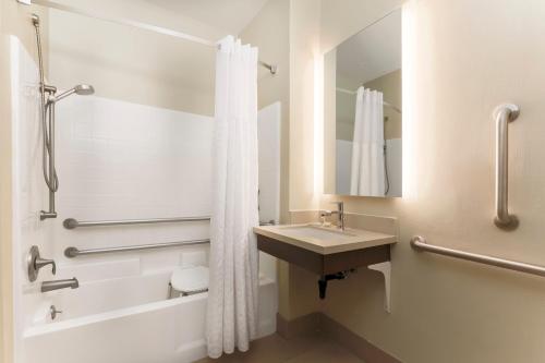 a bathroom with a sink and a tub and a shower at Staybridge Suites Reno Nevada, an IHG Hotel in Reno