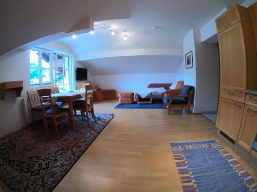 a living room with a table and chairs and a couch at Haus Hedwig in Fuschl am See