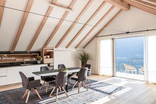 a kitchen and dining room with a table and chairs at Romy & Johannes Guesthouse in Schenna