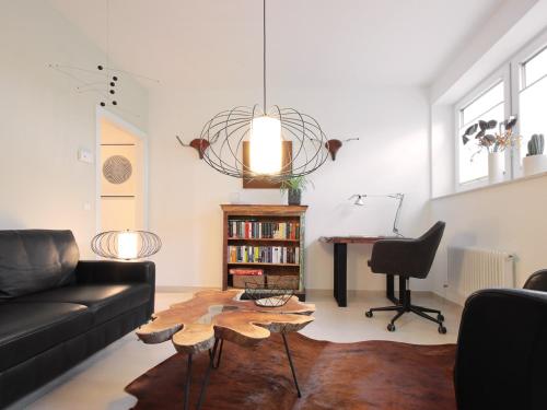 a living room with a couch and a table and a desk at Charming LOUISE in Saarbrücken