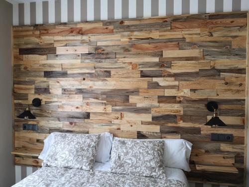 a wall made out of reclaimed wood at Hostal Juan Bravo in Segovia
