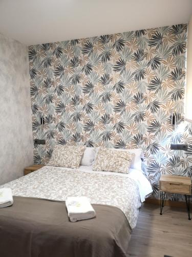 a bedroom with a large bed with a wall at Hostal Juan Bravo in Segovia