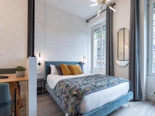 a bedroom with a blue bed and a desk at Luxury Studio "Le Chaleureux" - Lyon Part-Dieu - Dreamy Flat Lyon in Lyon