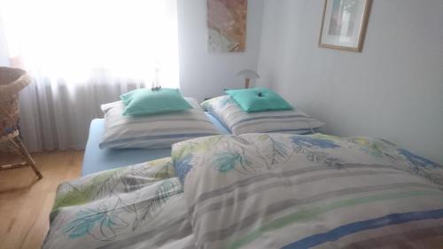 two beds in a room with green pillows on them at Down-Town-Oasis in Düsseldorf