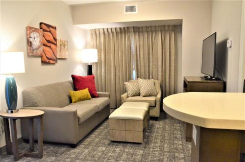 a living room with a couch and a chair at Staybridge Suites - Orenco Station by IHG in Hillsboro