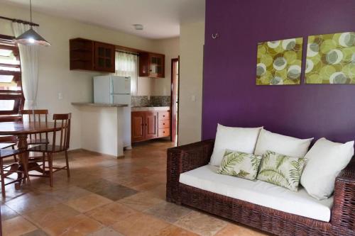 a living room with a couch and a dining room at Pousada Recreio Casa Grande in Cascavel