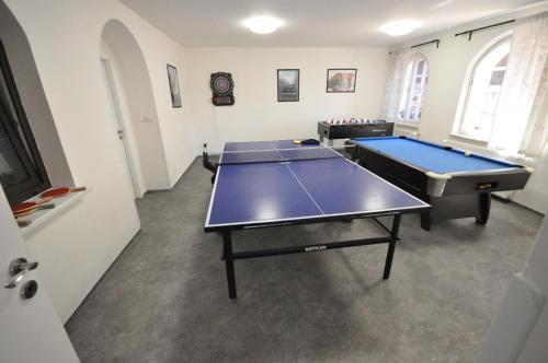 a room with two ping pong tables in it at Wellness Pension Fulda Černý Důl in Cerny Dul