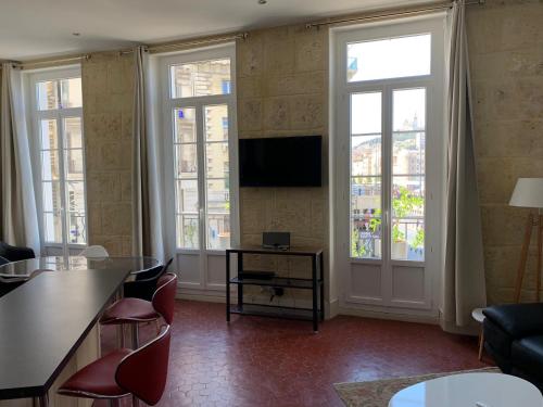 a living room with windows and a flat screen tv at Historique vieux port in Marseille