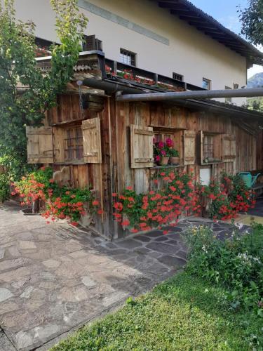 a building with flowers on the side of it at Maso Pinterato in Cavalese