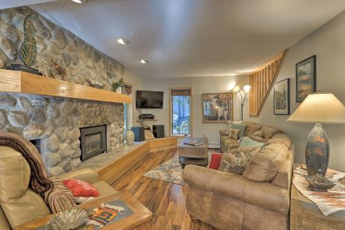 a large living room with a stone fireplace at Creekside Frisco Condo with Views and Pool Access! in Frisco