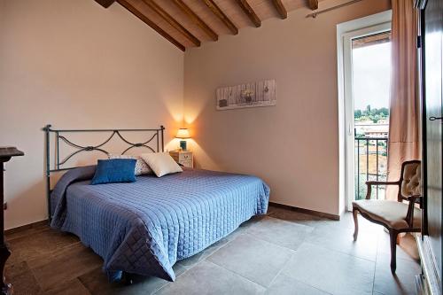 a bedroom with a bed and a large window at Casa Ciaccheri 2 in Gaiole in Chianti