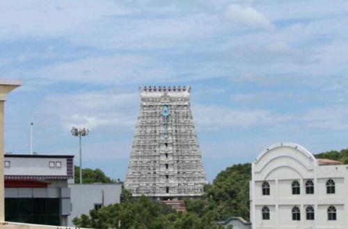 a clock tower in the middle of a city at Hotel Chitra Park in Thiruchendur