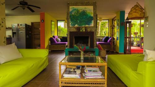 a living room filled with furniture and a fire place at Spondylus Lodge in Ayampe