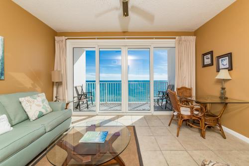 a living room with a couch and a glass table at Windemere Condominiums in Perdido Key