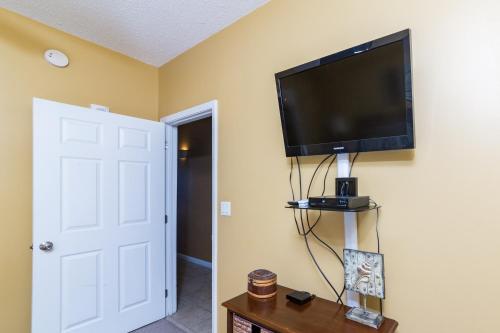 a room with a flat screen tv on a wall at Windemere Condominiums in Perdido Key