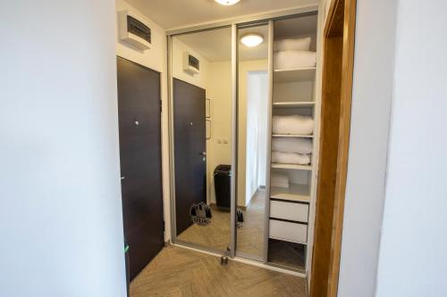 a bathroom with a mirror and a walk in closet at Jahorinski IZLOG in Jahorina