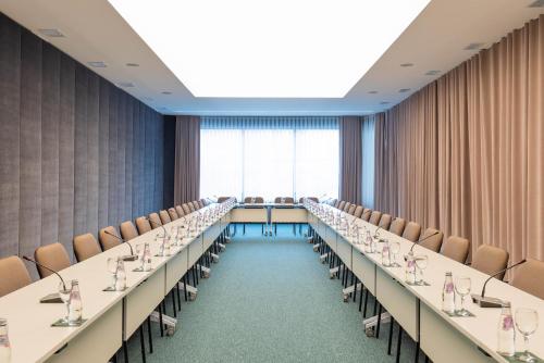 a long conference room with tables and chairs at Hotel Afa in Pristina