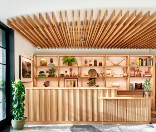 a restaurant with a wooden ceiling and shelves with plants at Hotel Magdalena in Austin