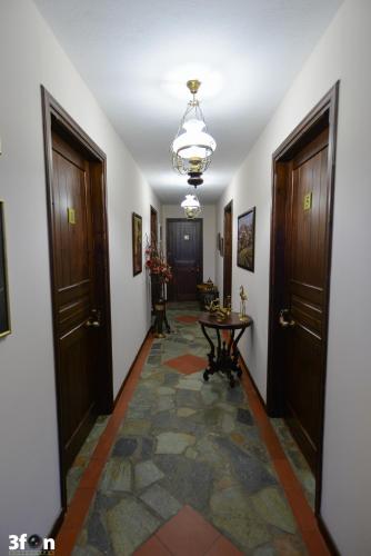 a hallway with two doors and a table at Guesthouse Kastro in Edessa