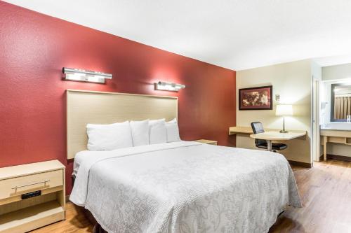 a hotel room with a large bed and a desk at Red Roof Inn PLUS+ Nashville North Goodlettsville in Goodlettsville