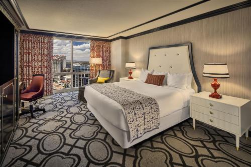 a hotel room with a large bed and a window at Paris Las Vegas Hotel & Casino in Las Vegas