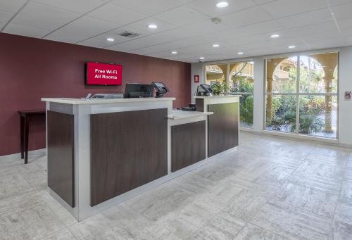 an office lobby with a reception desk with a sign on the wall at Red Roof Inn Tampa Bay - St. Petersburg in St. Petersburg