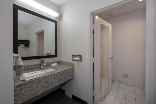 a bathroom with a sink and a mirror at Red Roof Inn Warrenton in Warrenton