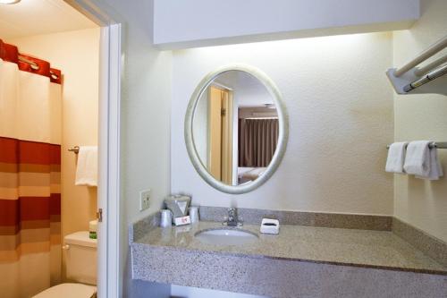 a bathroom with a sink and a mirror at Red Roof Inn Buffalo - Niagara Airport in Williamsville