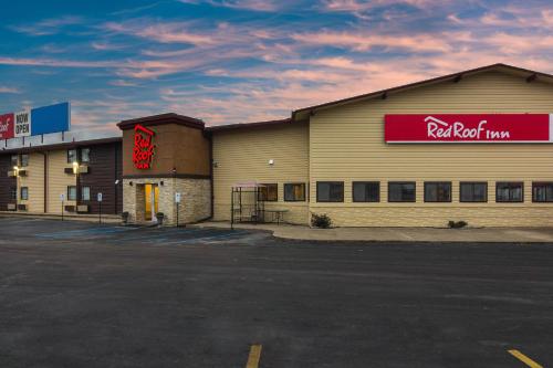 a building with a red sign on the side of it at Red Roof Inn Perrysburg in Perrysburg