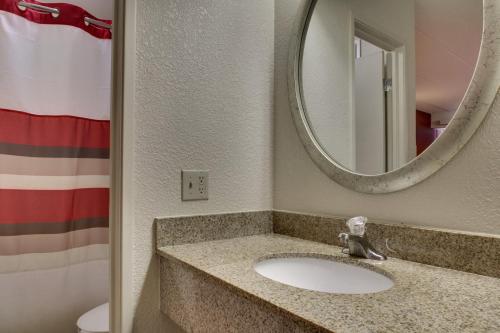 a bathroom with a sink and a mirror at Red Roof Inn St Louis - Westport in Saint Louis