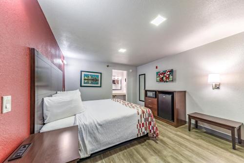 a hotel room with a bed and a desk at Red Roof Inn Dallas - Mesquite Fair Park NE in Mesquite