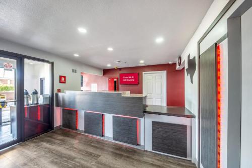 a restaurant kitchen with a counter with red walls at Red Roof Inn Dallas - Mesquite Fair Park NE in Mesquite