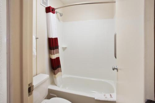 a bathroom with a toilet and a shower at Red Roof Inn PLUS+ Nashville Fairgrounds in Nashville