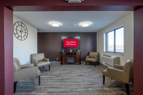 a waiting room with a tv and a fireplace at Red Roof Inn Greensburg in Greensburg