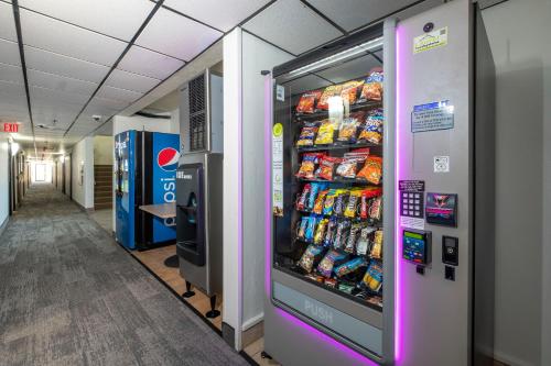 a vending machine filled with drinks in a hallway at Red Roof Inn Greensburg in Greensburg